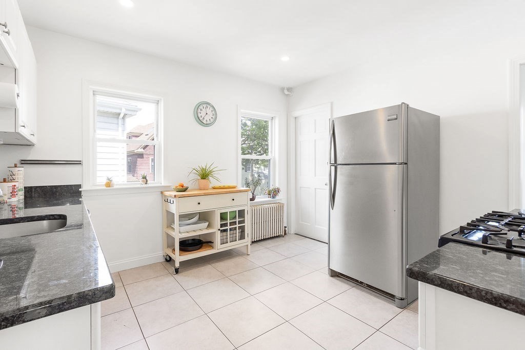 43 Sheffield Road, Unit 2 Boston, MA 02131 - Photo 3 of 16 a kitchen with a refrigerator and a stove