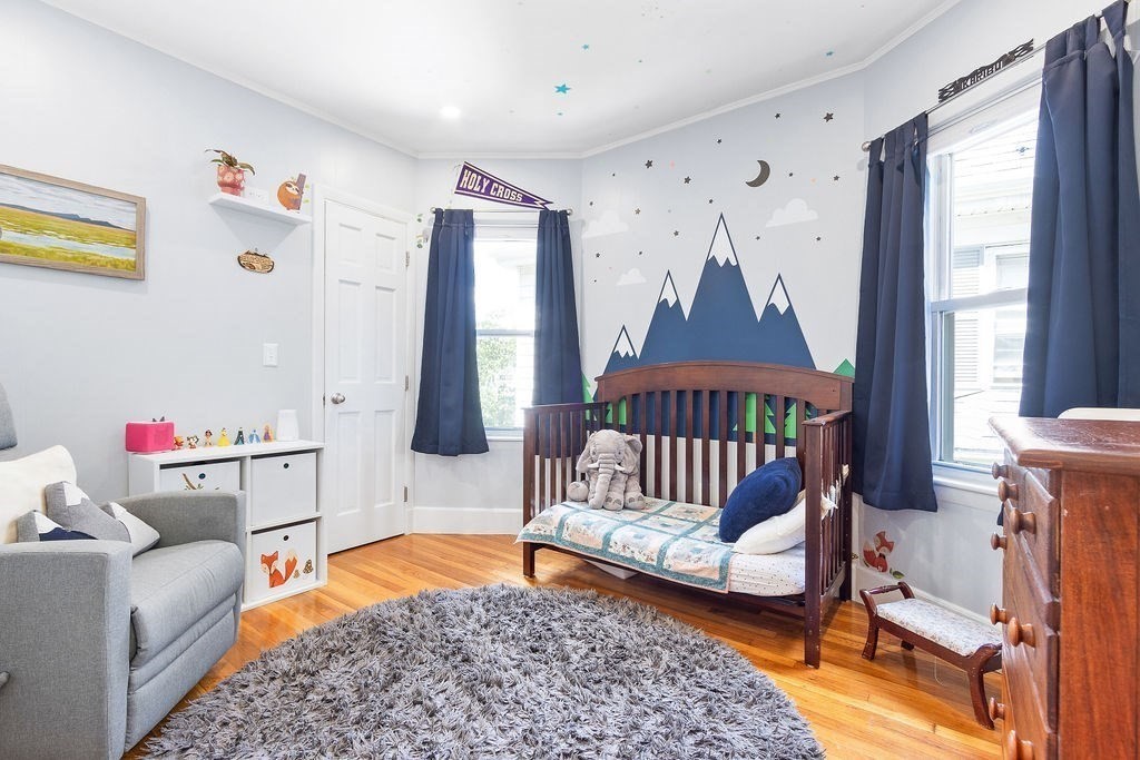 43 Sheffield Road, Unit 2 Boston, MA 02131 - Photo 9 of 16 a bedroom with a bed and wooden floor