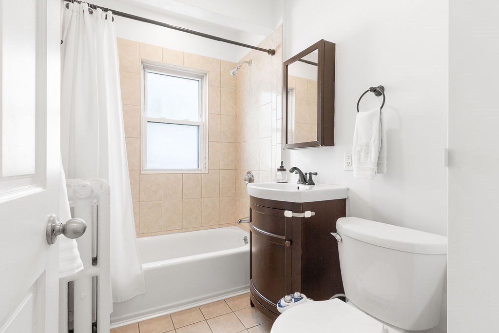43 Sheffield Road, Unit 2 Boston, MA 02131 - Photo 10 of 16 a bathroom with a sink a toilet and shower
