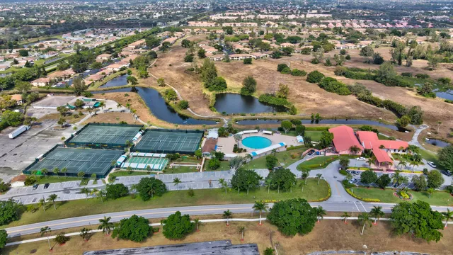 an aerial view of residential houses with outdoor space and parking