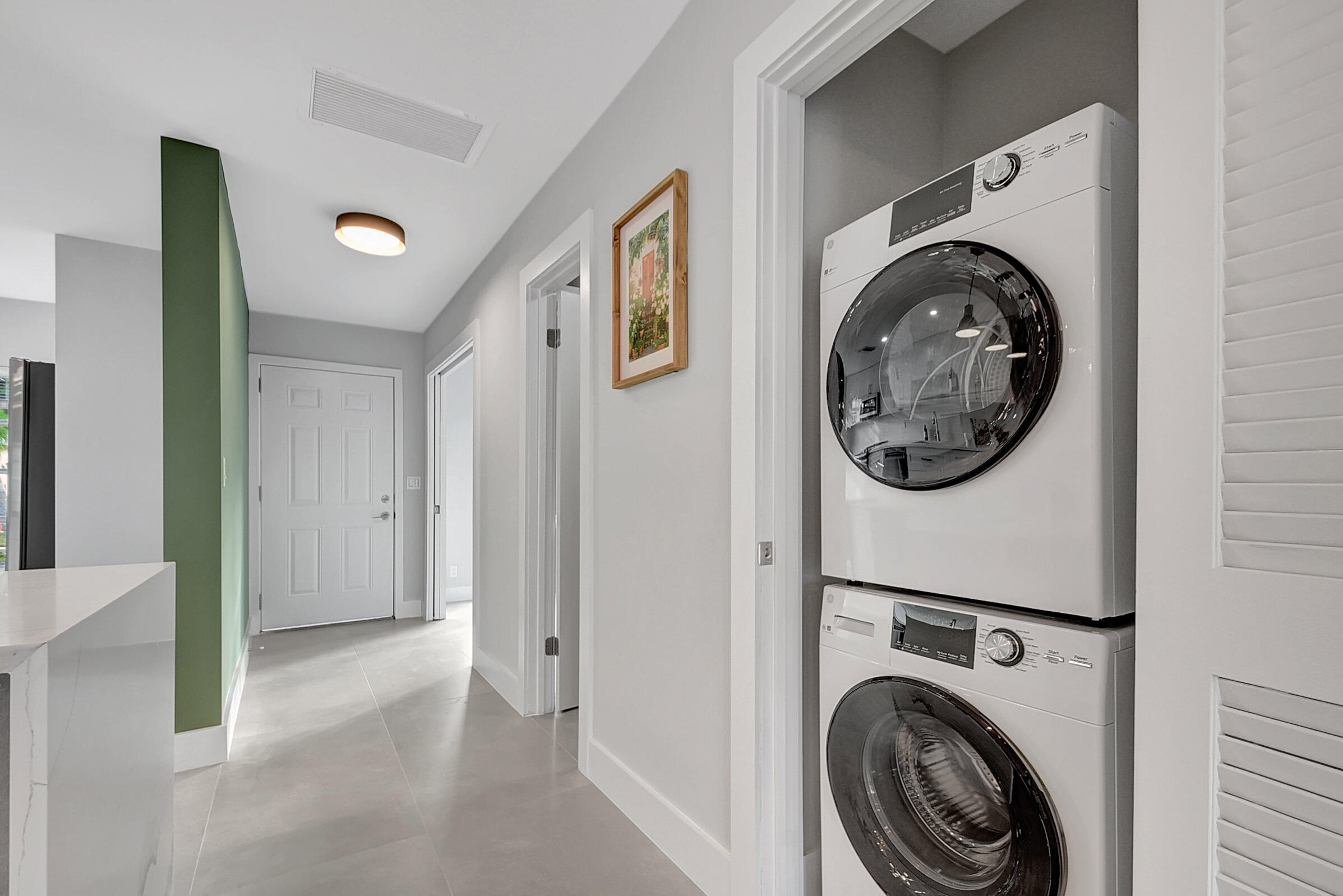 13602 Vía Flora, Unit C Delray Beach, FL 33484 - Photo 7 of 20 a view of a hallway with washer and dryer
