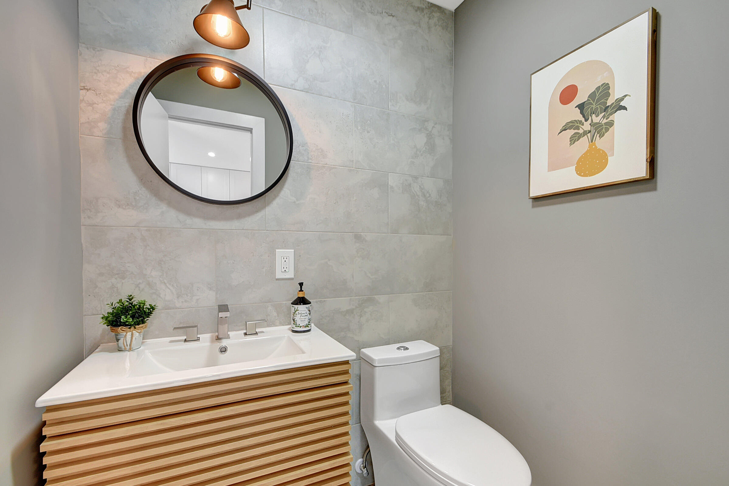 13602 Vía Flora, Unit C Delray Beach, FL 33484 - Photo 10 of 20 a bathroom with a sink a mirror and a toilet