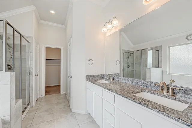 a spacious bathroom with a granite countertop sink and a mirror
