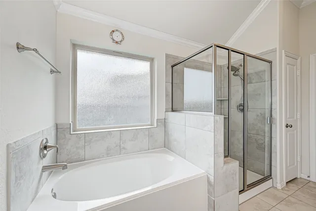 a white bath tub sitting next to a shower