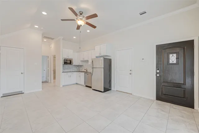 a view of a kitchen with refrigerator and an oven