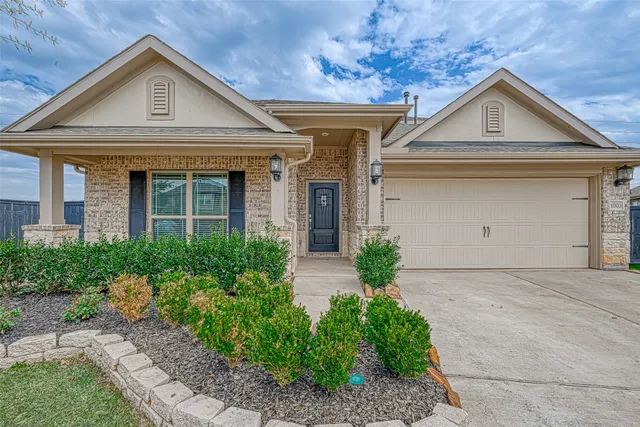 a front view of a house with garden