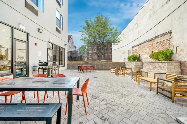 a view of a patio with a dining table and chairs