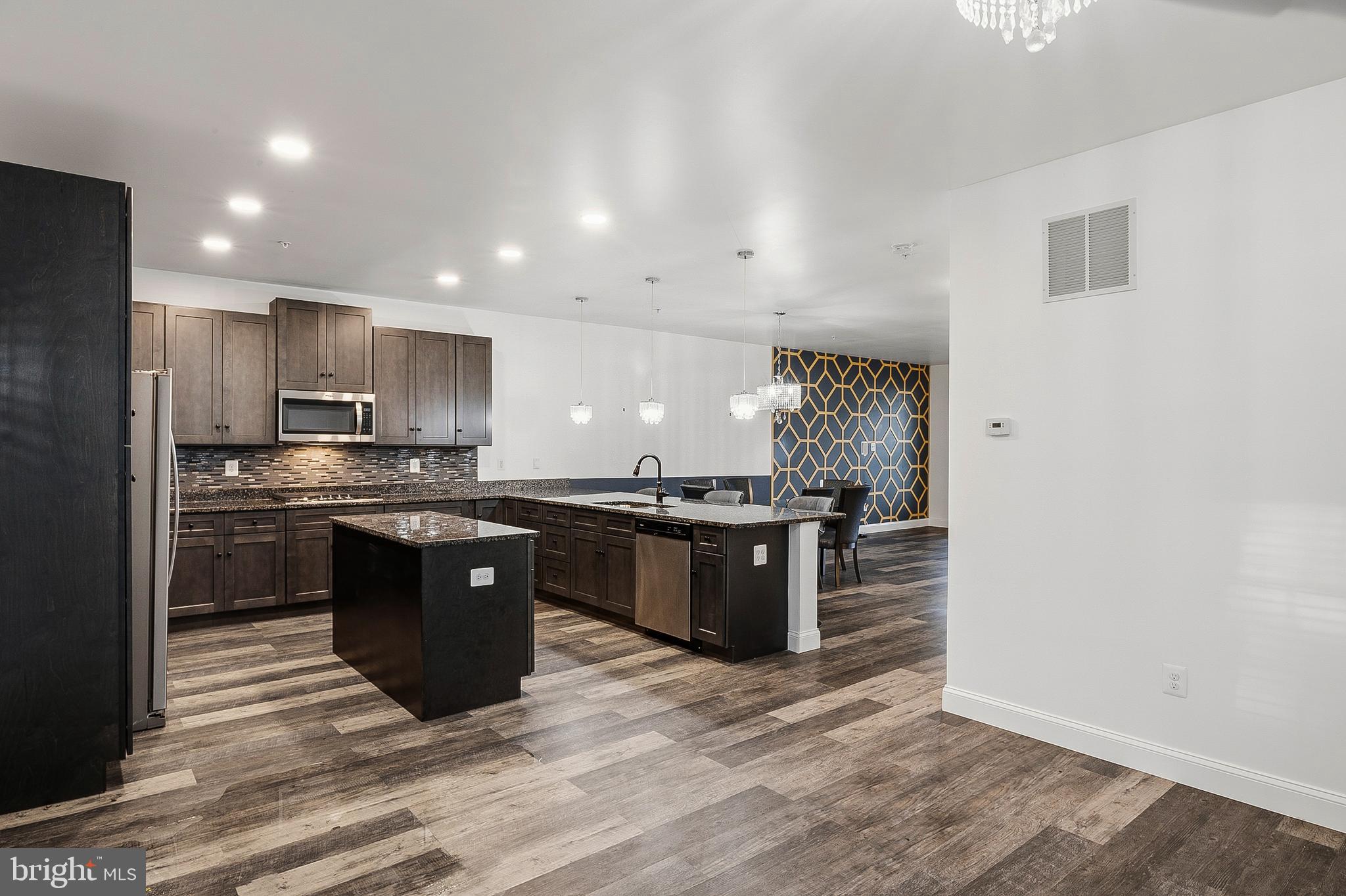 33 Greensborough Road Reisterstown, MD 21136 - Photo 15 of 40 a kitchen with stainless steel appliances granite countertop a stove a sink and a refrigerator