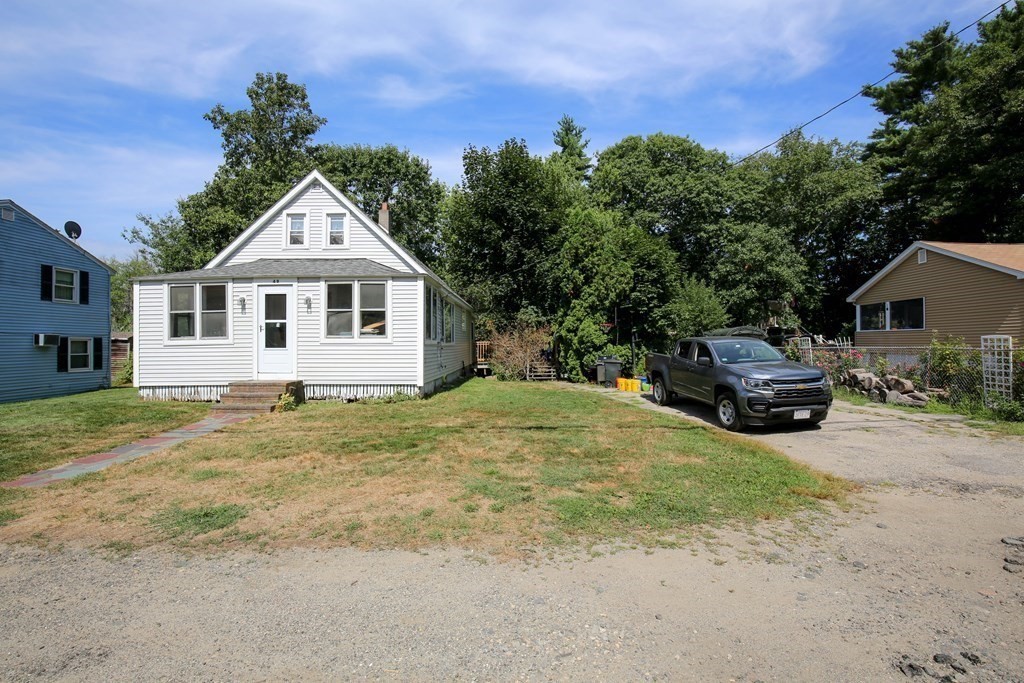 49 Rabbit Road Salisbury, MA 01952 - Photo 24 of 29 a front view of a house with a garden