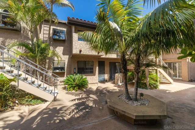 a front view of a house with plants