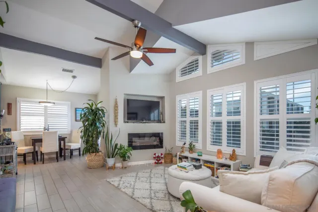 a living room with furniture a large window and a fireplace