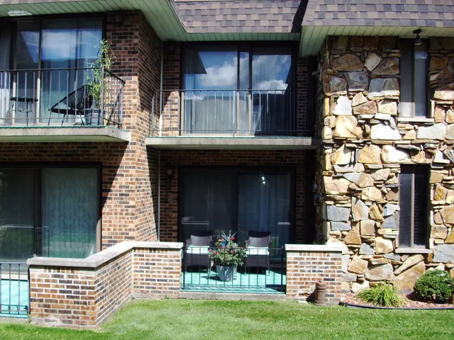 a view of a chair and table in backyard of the house