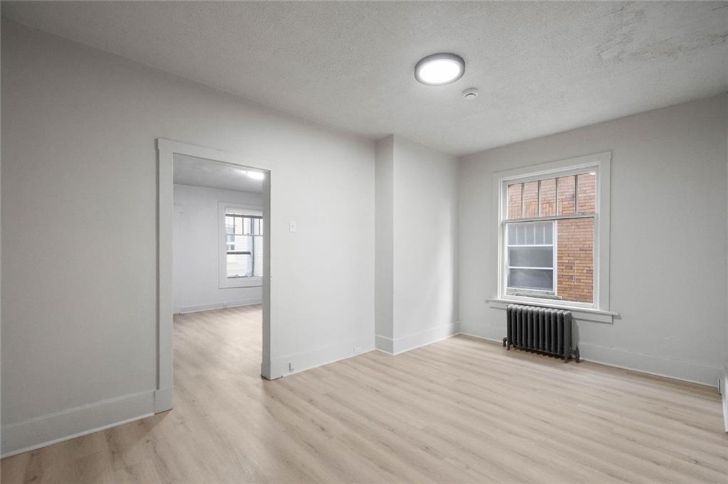 306 Park Road Ambridge, PA 15003 - Photo 5 of 43 a view of empty room with wooden floor and fan