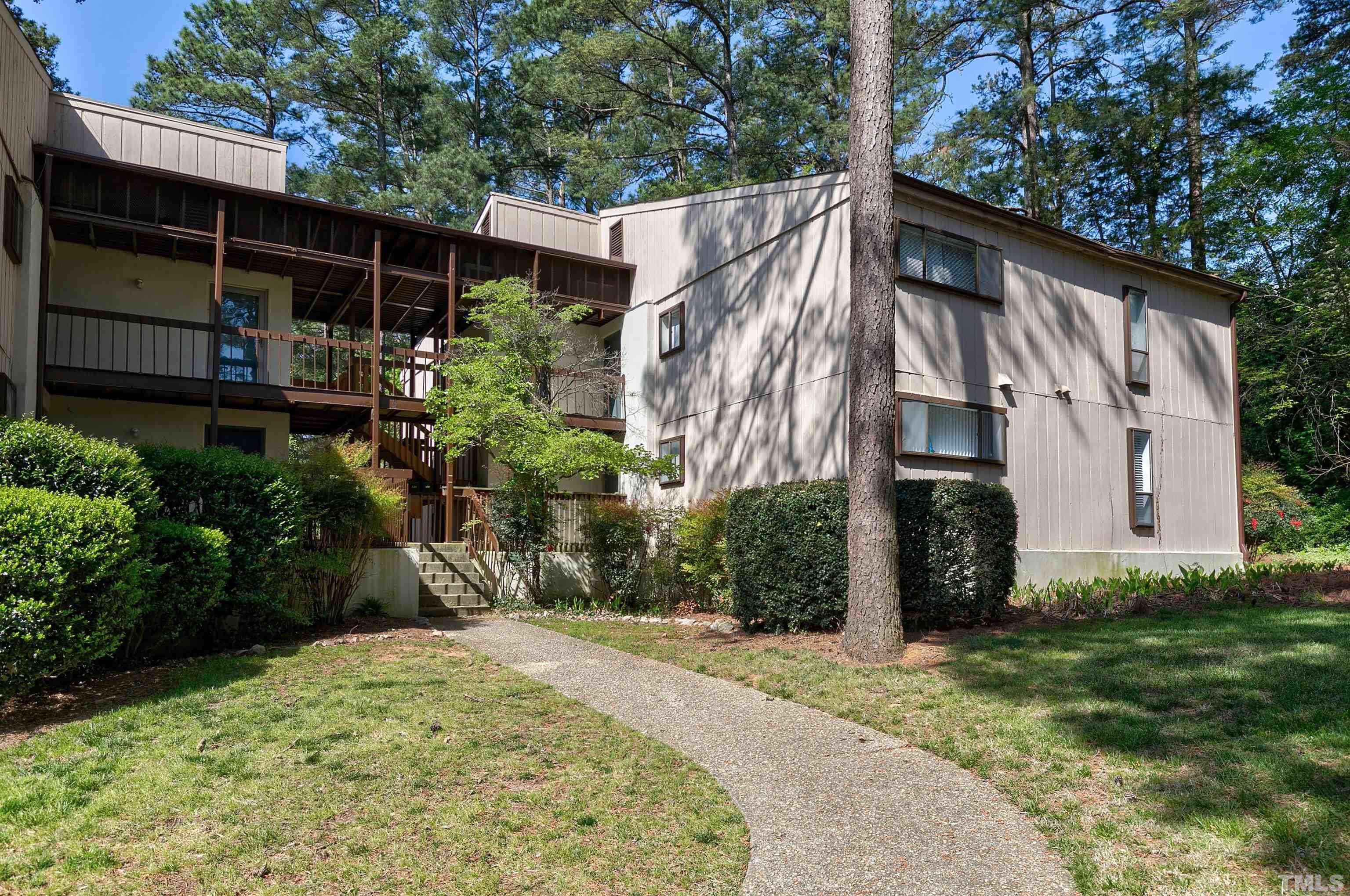541 Pine Ridge Place, Unit 541 Raleigh, NC 27609 - Photo 1 of 21 a backyard of a house with lots of green space