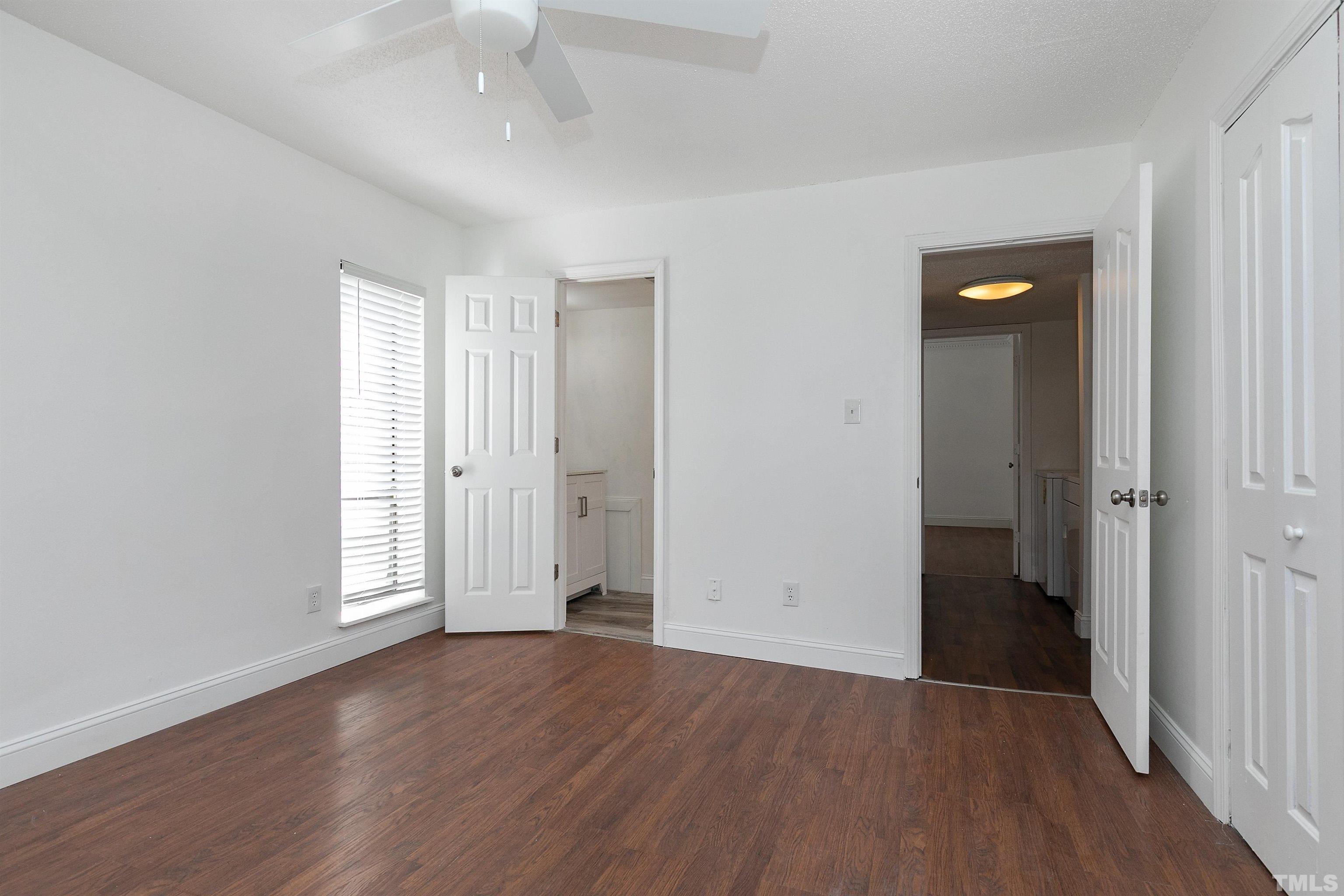 541 Pine Ridge Place, Unit 541 Raleigh, NC 27609 - Photo 16 of 21 an empty room with wooden floor and windows