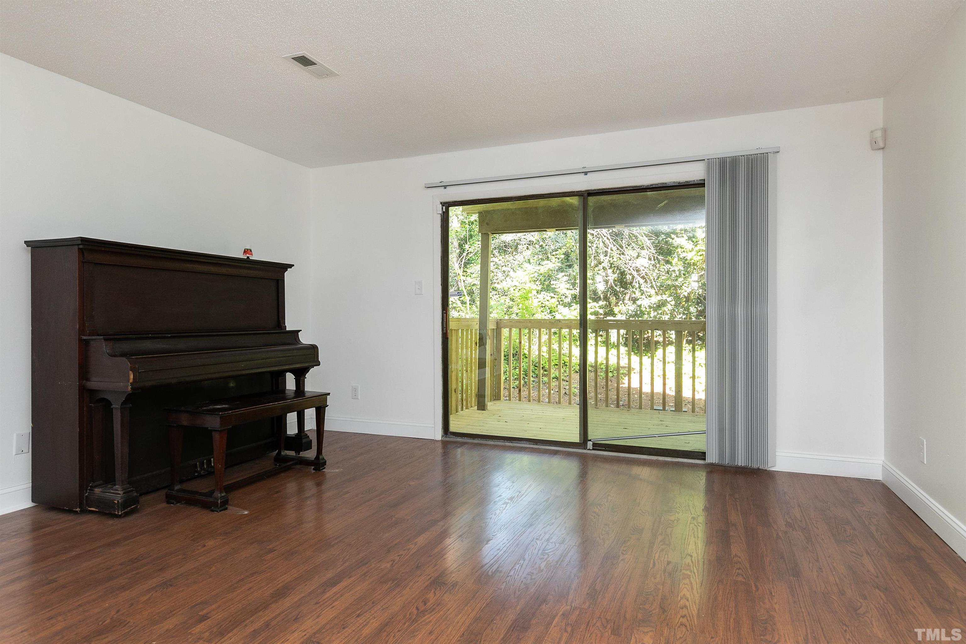 541 Pine Ridge Place, Unit 541 Raleigh, NC 27609 - Photo 8 of 21 a view of a livingroom with wooden floor and a fireplace
