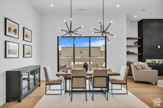 2761 West Lava Hls Road Santa Clara, UT 84765 - Photo 4 of 53 Dining room featuring light wood-style flooring, recessed lighting, a tile fireplace, and a chandelier