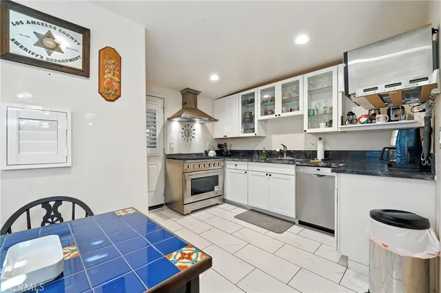 a view of a backyard with table and chairs under an umbrella