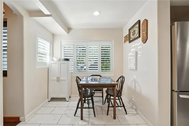 a bedroom with a bed next to a window