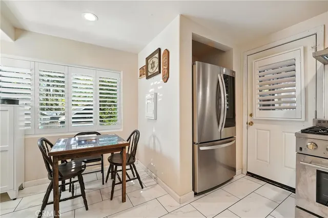 a kitchen with stainless steel appliances granite countertop a refrigerator and a stove