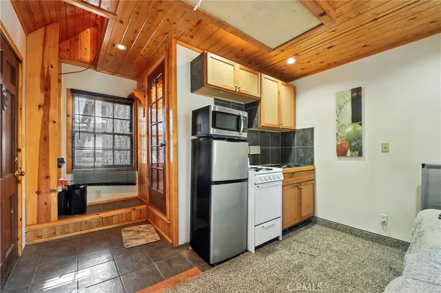 a view of a balcony with wooden floor and fence