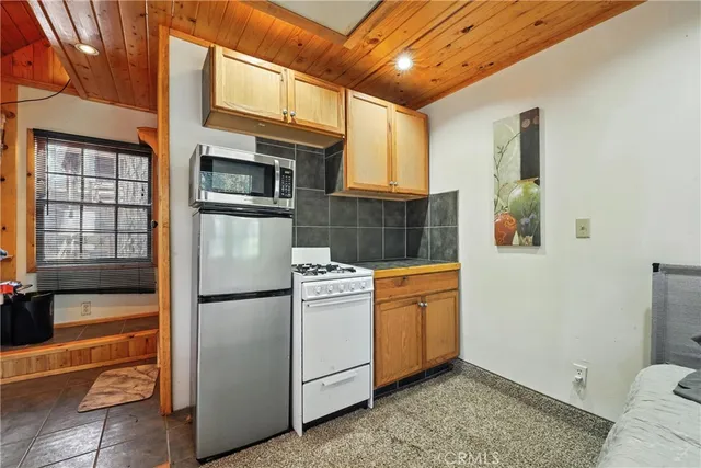 a view of a lush green forest with a mountain