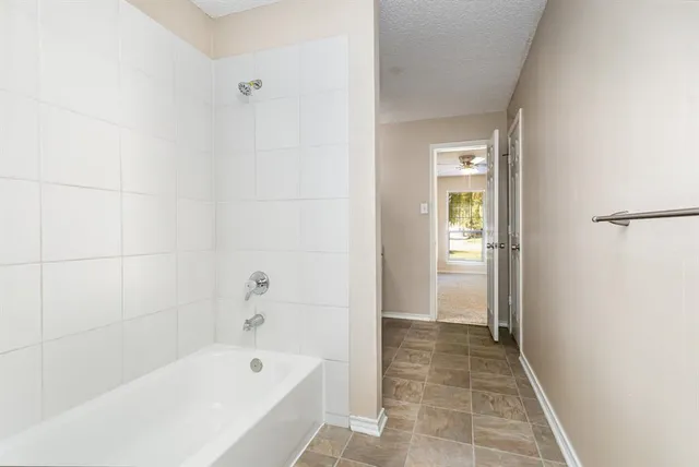 a bathroom with a bathtub and a shower
