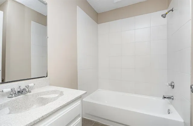 a white bath tub sitting next to a white sink