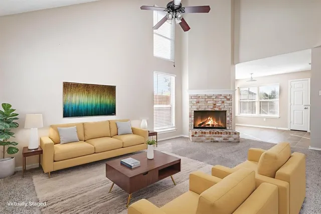 a living room with furniture and a fireplace