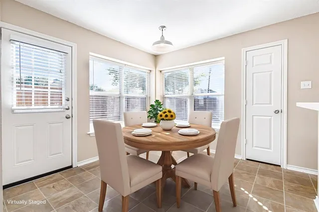 a dining room with furniture and window