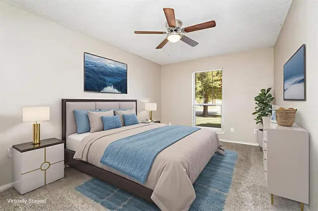 a bedroom with a large bed and a chandelier