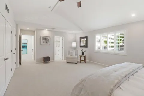 a bedroom with a bed and a large window