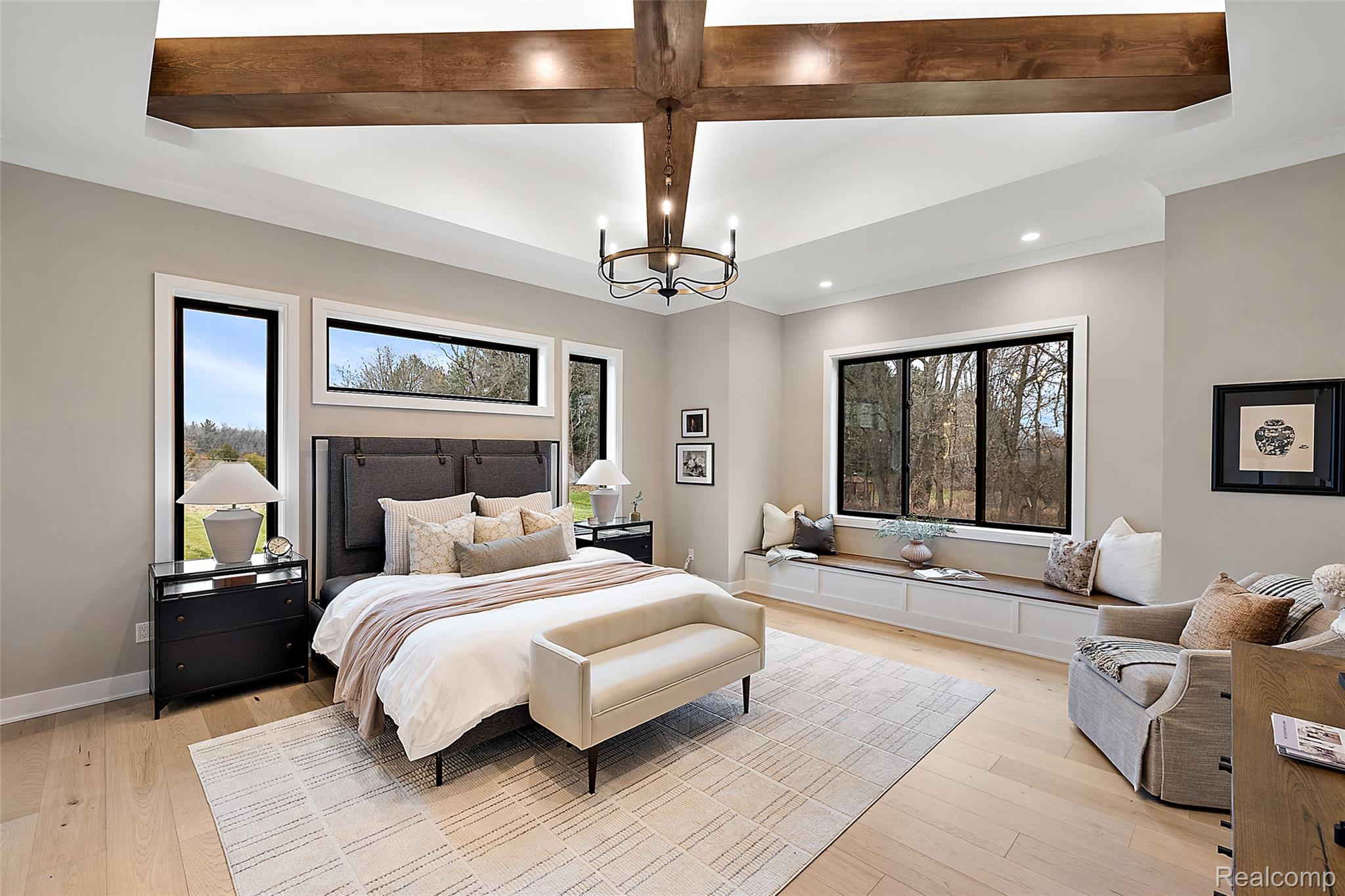 70413 Renata Court Romeo, MI 48065 - Photo 35 of 53 Luxurious primary bedroom showcasing vaulted ceilings with exposed wood beams and recessed lighting, wide-plank wood-finish flooring, and abundant natural light from multiple large windows