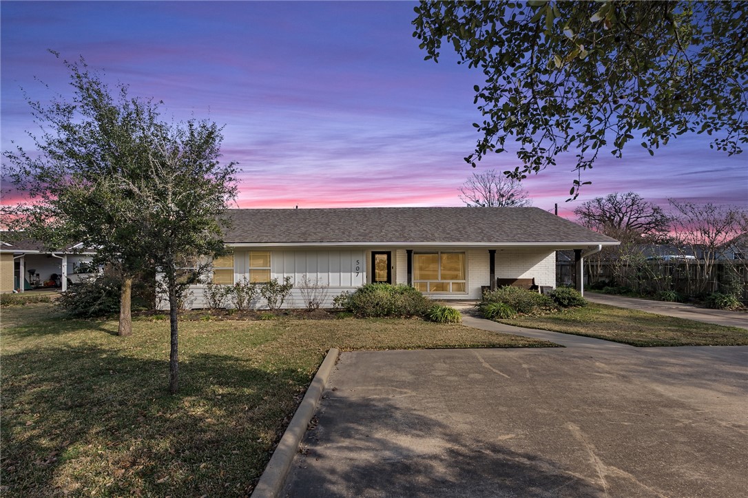 507 Crescent Drive Bryan, TX 77801 - Photo 1 of 41 a front view of a house with a yard and trees