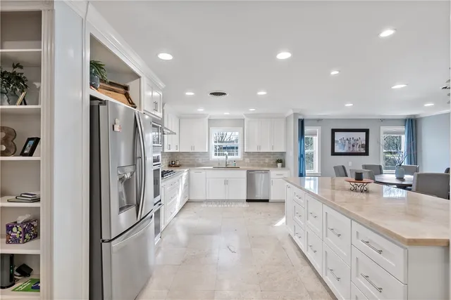 a large kitchen with stainless steel appliances lots of counter top space