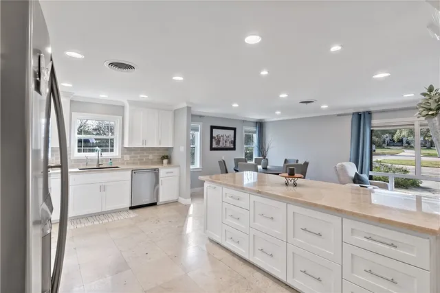 a kitchen with counter top space sink and refrigerator