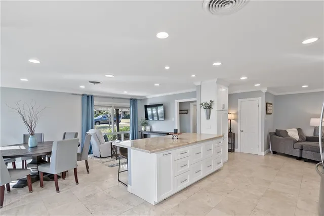 a large room with a large window and furniture