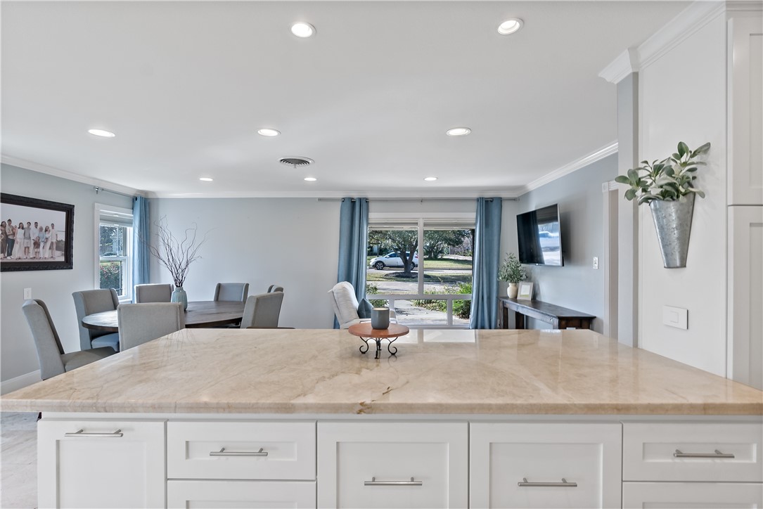 507 Crescent Drive Bryan, TX 77801 - Photo 18 of 41 a dining hall with stainless steel appliances granite countertop a sink dishwasher and a dining table with wooden floor