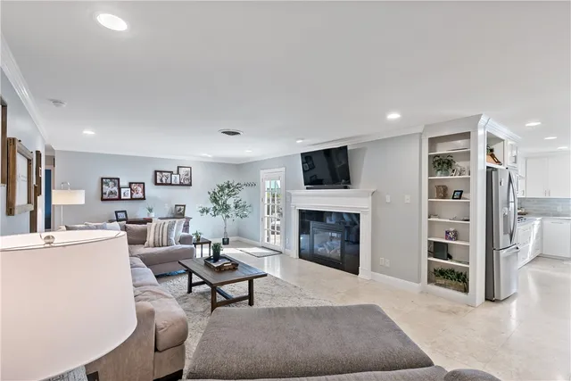 a living room with furniture a fireplace and a flat screen tv