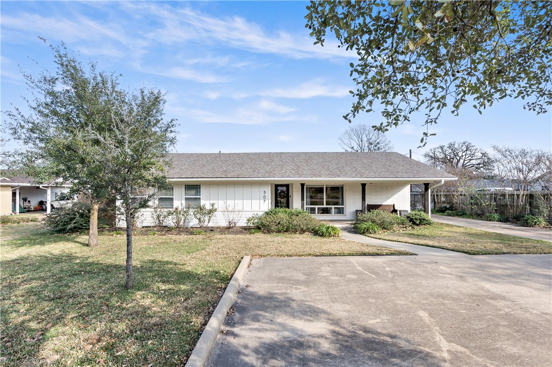 507 Crescent Drive Bryan, TX 77801 - Photo 2 of 41 a front view of a house with a yard and potted plants