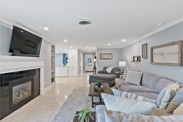 a living room with furniture a fireplace and a flat screen tv