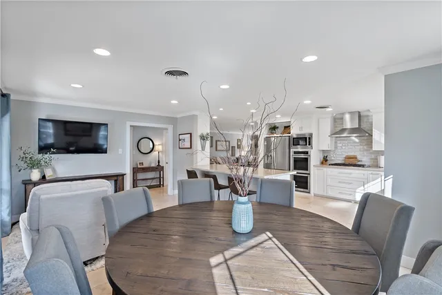 a dining room with furniture and a flat screen tv