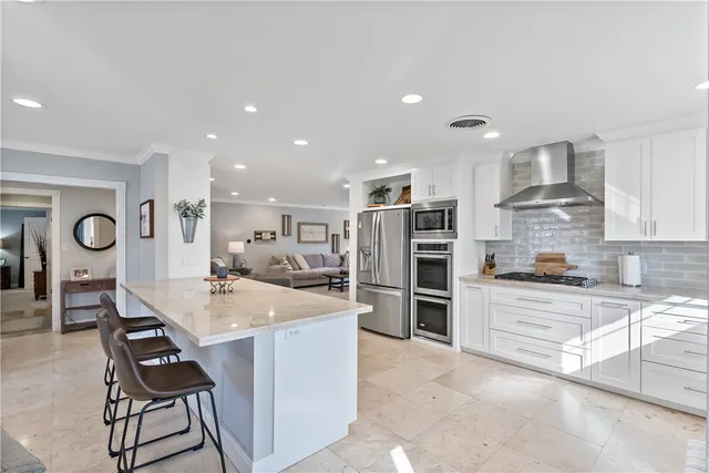 a kitchen with stainless steel appliances kitchen island granite countertop a sink and cabinets