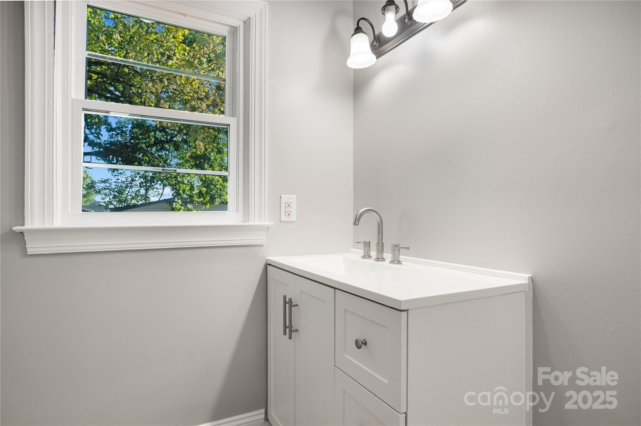 1306 South Main Street Mount Holly, NC 28120 - Photo 11 of 18 a bathroom with a sink and a vanity