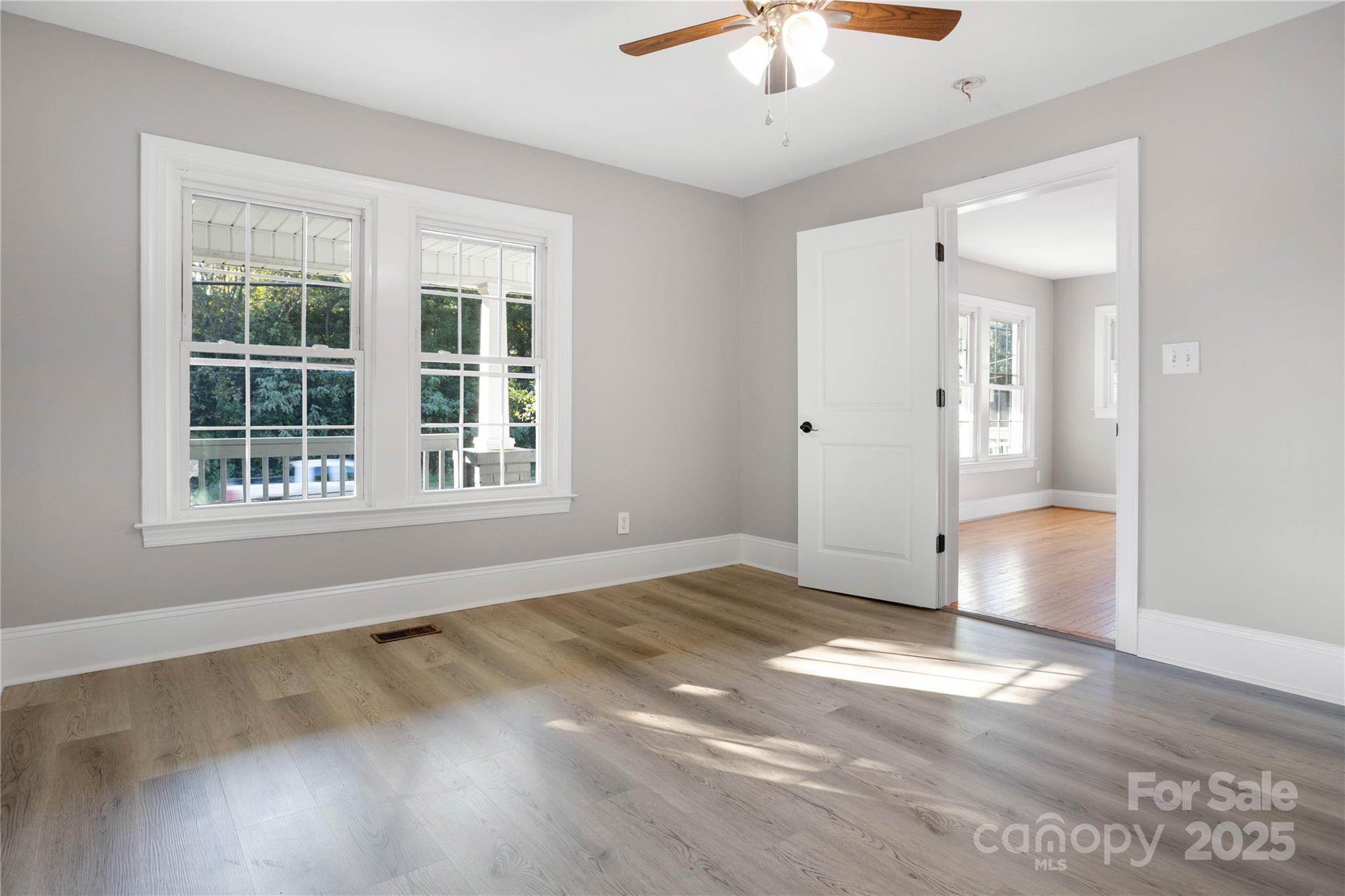 1306 South Main Street Mount Holly, NC 28120 - Photo 12 of 18 a view of an empty room with a window and wooden floor