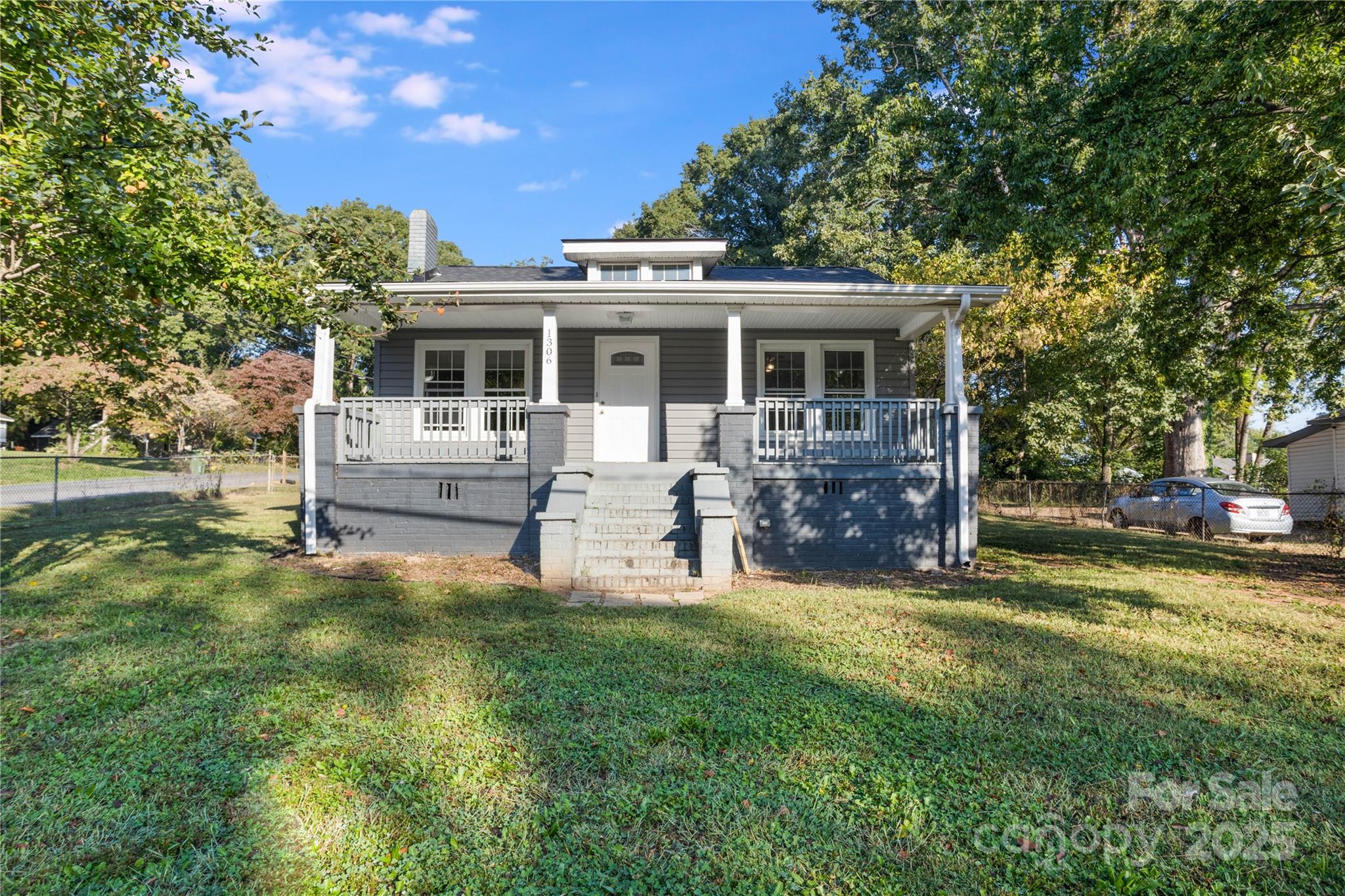 1306 South Main Street Mount Holly, NC 28120 - Photo 15 of 18 a view of a house with a big yard and large trees