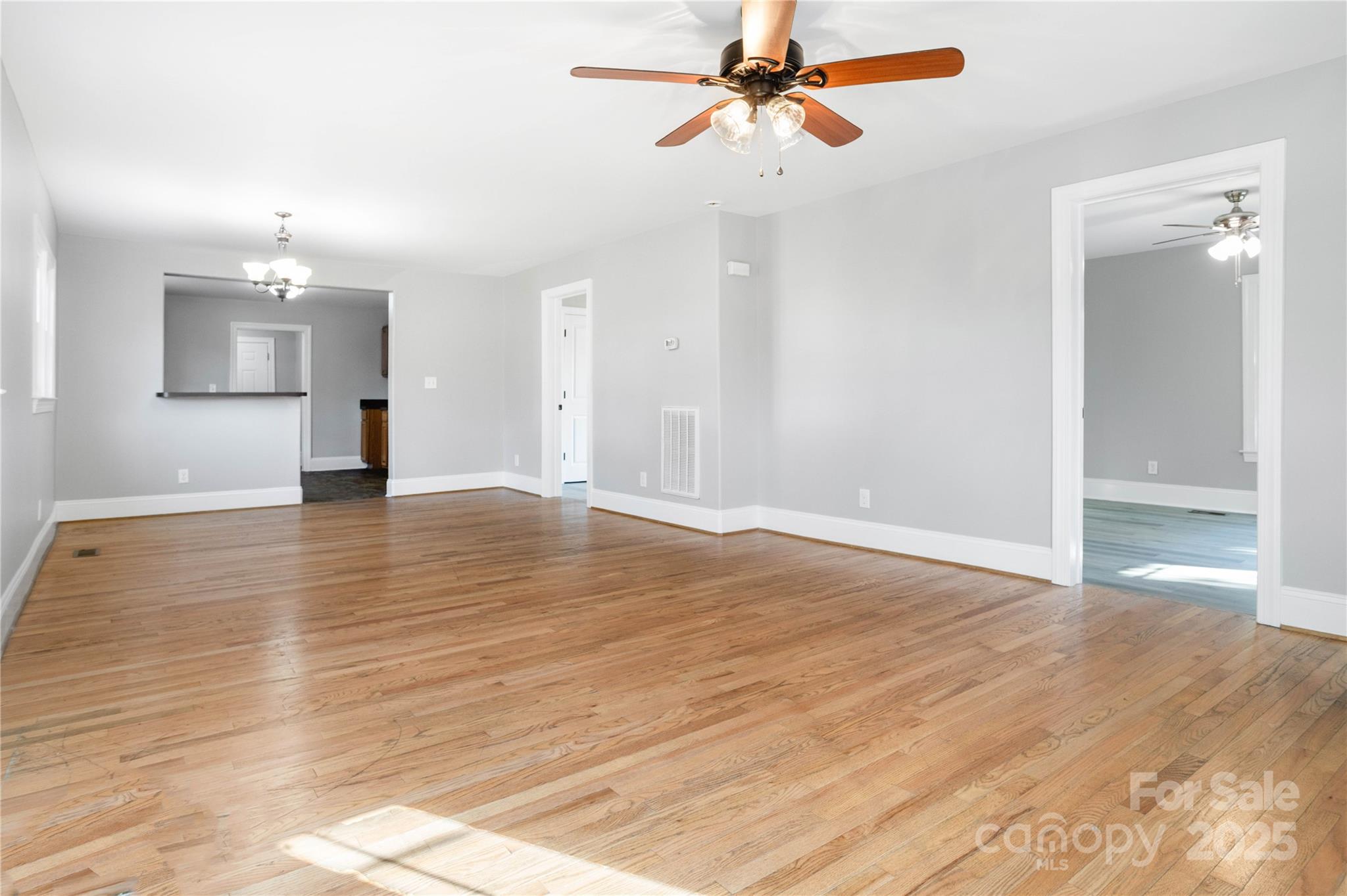 1306 South Main Street Mount Holly, NC 28120 - Photo 3 of 18 wooden floor in an empty room with a window