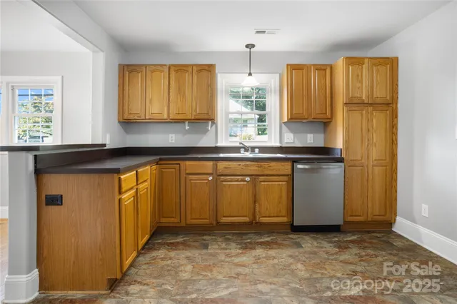 a kitchen with stainless steel appliances granite countertop a refrigerator sink and cabinets