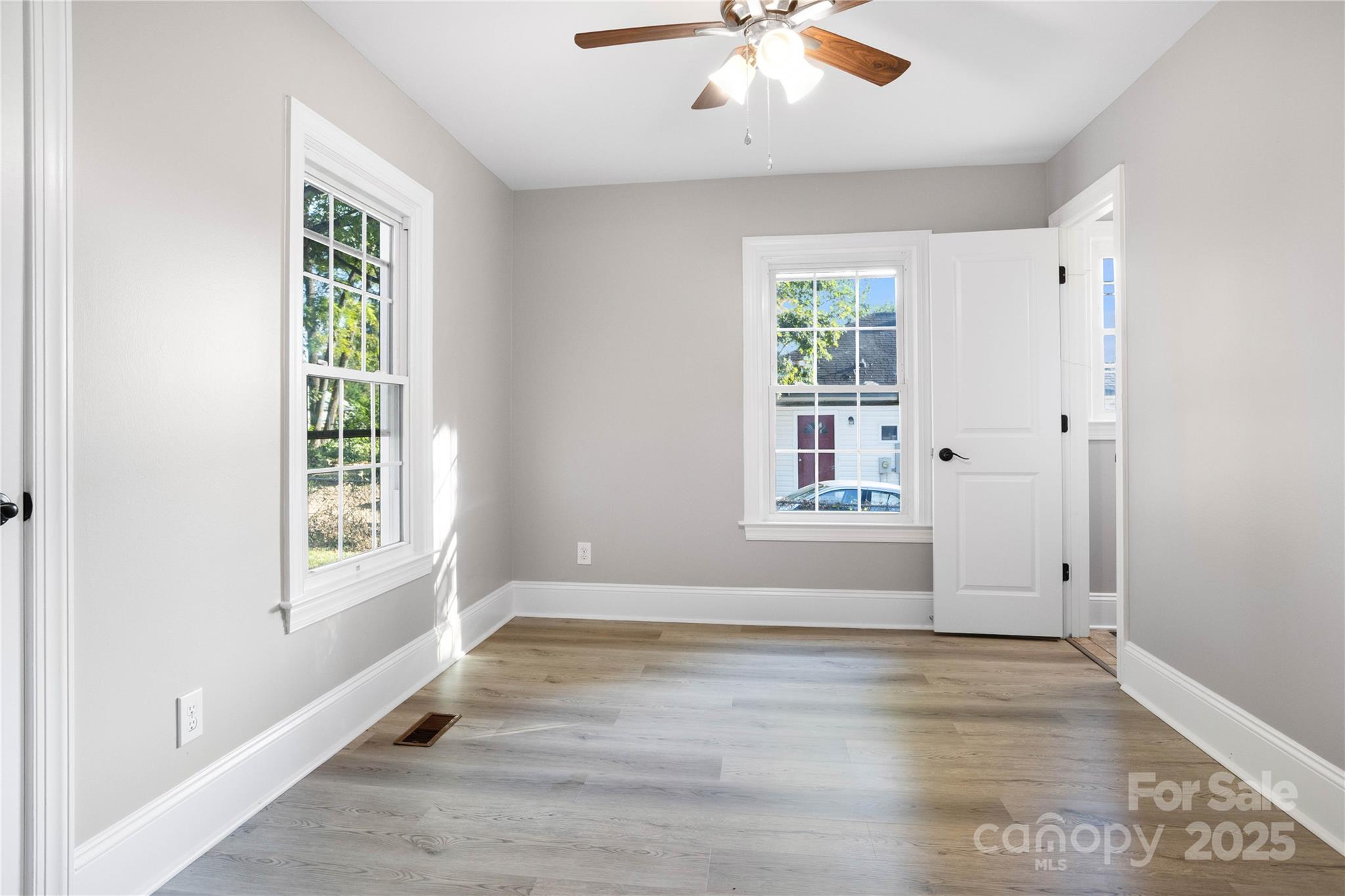 1306 South Main Street Mount Holly, NC 28120 - Photo 6 of 18 wooden floor in an empty room with a window
