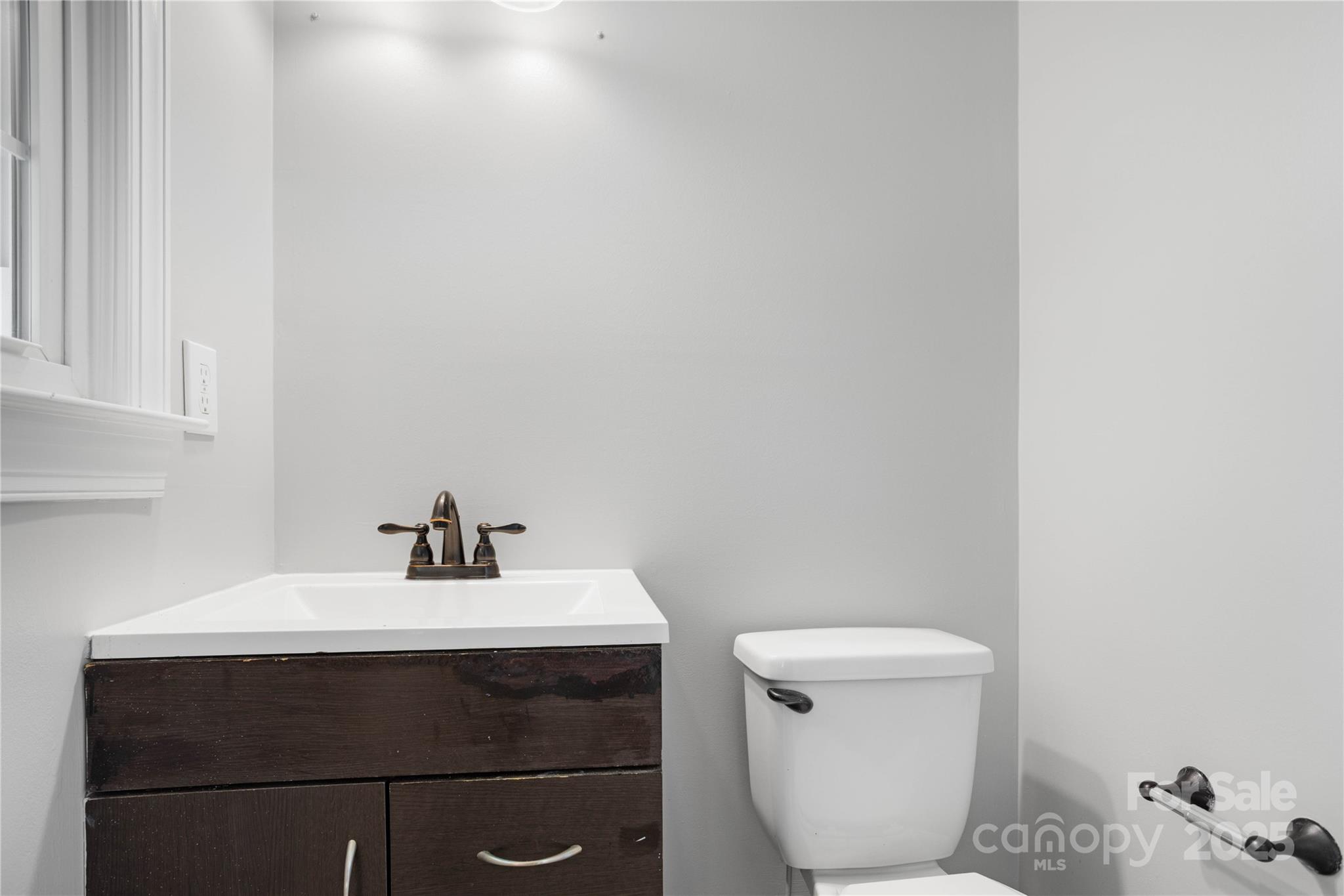 1306 South Main Street Mount Holly, NC 28120 - Photo 7 of 18 a bathroom with a sink and a toilet